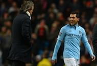 Manchester City's Carlos Tevez speaks to manager Roberto Mancini during the match against Barnsley March 9, 2013